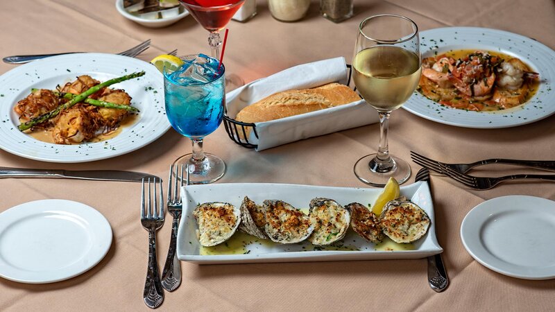 Multiple appetizers with focus on Clams on the half shell