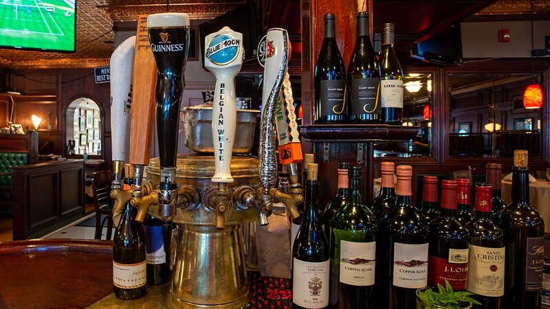 Beer taps and bottles of wine at the bar